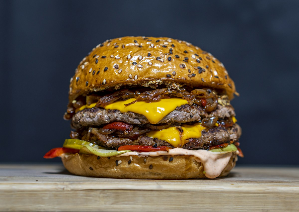 Illustrative double cheeseburger photography, not an exact EAT menu photograph